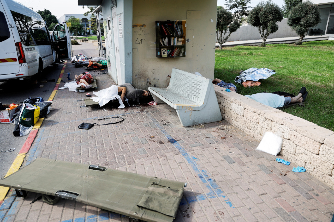 cadáveres de varias personas yaciendo en una calle tras ser asesinadas durante una infiltración masiva de hombres armados de Hamás, en Israel. Foto: Reuters