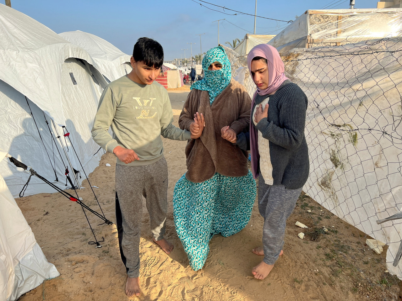 Palestinos se refugian en una tienda de campaña, en Rafah, Gaza. Reuters