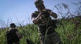 Soldado ucraniano se cubre los oídos mientras otro prepara para cargar un mortero durante una misión contra la infantería rusa en la región de Donetsk al este de Ucrania. Reuters