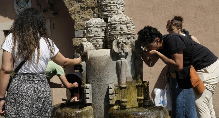 Varias personas se refrescan en una fuente en Roma, Italia. Foto: EFE.
